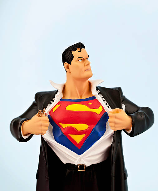 Clark Kent becomes Superman "Suffolk, Virginia, USA - May 22, 2011: A vertical studio shot of the cartoon Superhero character Superman as he emerges from his alter ego Clark Kent. Superman is owned by DC comics and Warner Bros." morph transition stock pictures, royalty-free photos & images