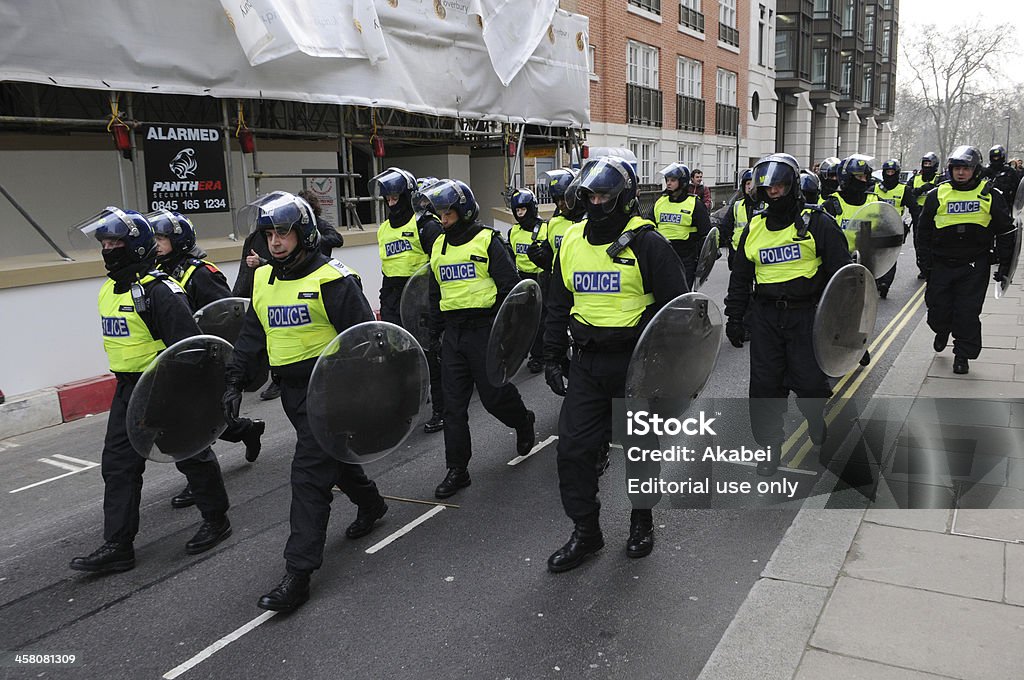 Riot Police in London "London, UK - March 26, 2011: Police in riot gear advance through central London after violent clashes during a large austerity protest on March." Riot Stock Photo