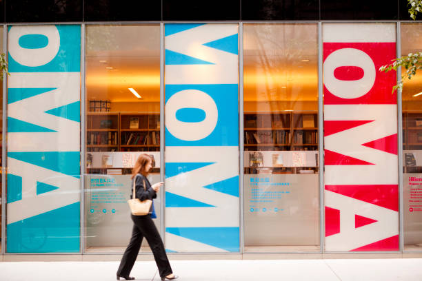 Woman Walks by Museum of Modern Art Store Manhattan stock photo