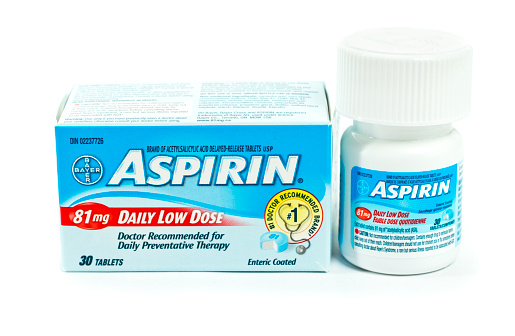 Chatham, Ontario, Canada - February 17, 2011: Box and Bottle Of 30, 81 mg Daily Low Dose Bayer Aspirin. Low dose aspirin is a commonly used preventative for heart attacks.  Aspirin is a product of Bayer AG.