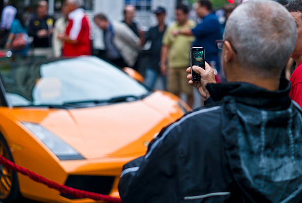 Taking pictures of a 2006 orange Lamborghini Gallardo Spyder stock photo