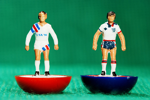 Pila, Italy - May 26, 2011: Vintage Subbuteo miniature toy of 2 soccer players of the US and English national team. Subbuteo is a set of table top games simulating team sports such as soccer, cricket, rugby and hockey created by Peter Adolph.