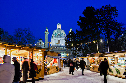 Vienna, Austria - December 14, 2010: tourists and locals at the tiny Christmas market in Resselpark between Karlskirche and the Technical University. This market is focused on authentic handicrafts made by local artists, and sometimes you can attend demonstration workshops of handicraft.