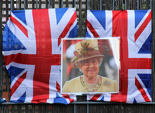 Diamond Jubilee celebrations: Queen Elizabeth II and Union Flags "London, England - June 2, 2012: Union flags and an image of Queen Elizabeth II are displayed on a wicker fence in Rotherhithe, south London, during the Thames Diamond Jubilee Pageant." elizabeth ii photos stock pictures, royalty-free photos & images