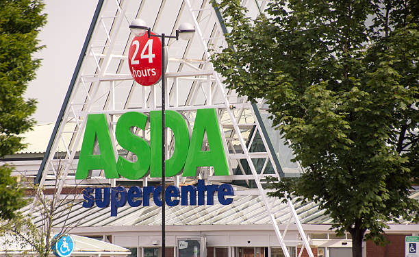 Asda 24 hours Supercentre "Leeds, England - August 8, 2013: The entrance of an Asda 24 hours Supercentre in Pudsey, West Yorkshire.  Asda is a leading supermaket chain in the UK, and a subsidiary of Wal-Mart." asda photos stock pictures, royalty-free photos & images