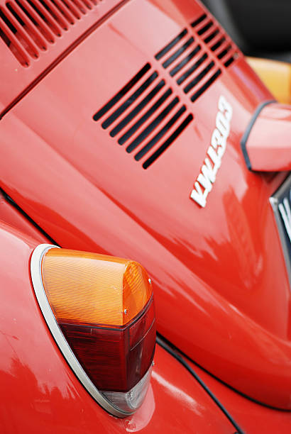 Borgosesia, Italy - September 19, 2011: Old red Volkswagen Beetle model VW 1303 parked in a parking lot in Borgosesia, close up on tail light, boot and logo.