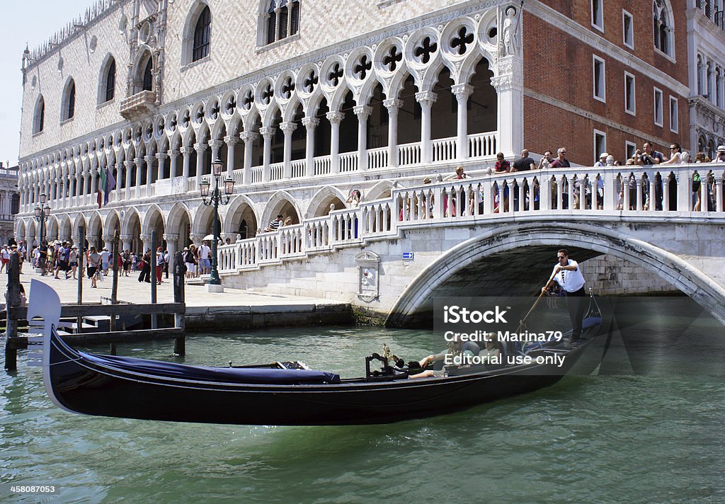 Venice, Italy "Venice,Italy - June 23, 2013: Palazzo Ducale from the lagoon the Grand Canal. Gondola with tourists sails under a bridge near the Doges palace in Venice, Italy on June 23, 2013." Architecture Stock Photo