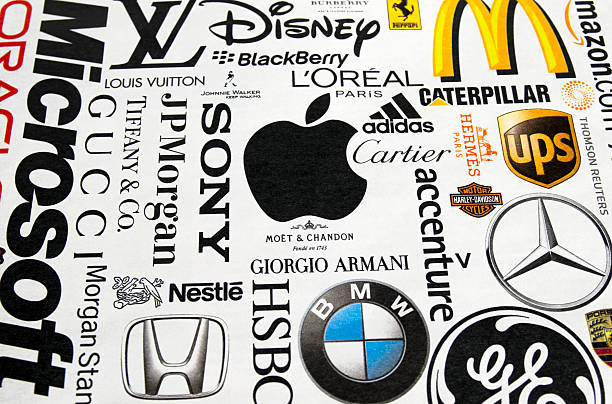 Logos printed in a magazine "London, England - October 19, 2011: A collection of well-known international brand names printed in a magazine. Names include Microsoft, Gucci, JP Morgan, Disney, BlackBerry, L'Oreal, Caterpillar, McDonalds, Cartier, adidas, Hermes, UPS, Harley Davidson, Mercedes, GE, Thomson Reuters, HSBC, BMW, Honda, Nestle, Morgan Stanley, Tiffany, Moet + Chandon, Giorgio Armani, Porsche, Ferrari, Amazon, Burberry, Apple, Accenture, Johnnie Walker and Louis Vuitton. Paper texture and slightly off-set registration visible; perspective shot." moet chandon stock pictures, royalty-free photos & images