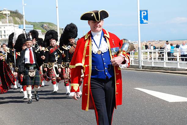 St.George's Day parade, Hastings "Hastings, England - April 26, 2009: John Bartholomew, Town Crier, leads a St.George\'s Day parade along the seafront at Hastings, East Sussex." town criers stock pictures, royalty-free photos & images