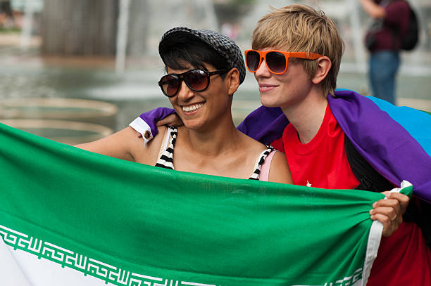 Stockholm Pride Parade 2012 "Stockholm, Sweden aa August 4, 2012: Two joyful young men posing with a flag at Stockholm Pride Parade which attracted an estimated 50000 participants and 500000 spectators." gay man men sunglasses party stock pictures, royalty-free photos & images