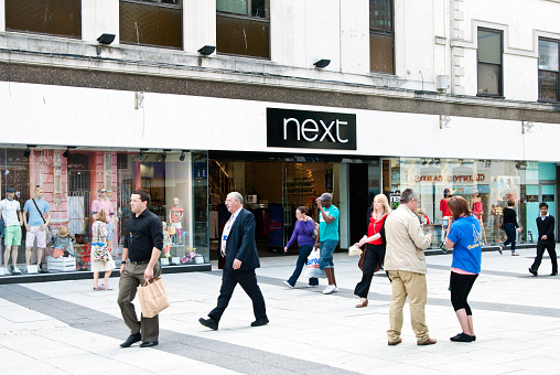 Cardiff, Wales - June 9, 2011: people shopping at the Next store in Cardiff, Wales. 