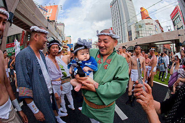 Japanese man and baby at the Ogion festival Kagoshima, Japan. stock photo