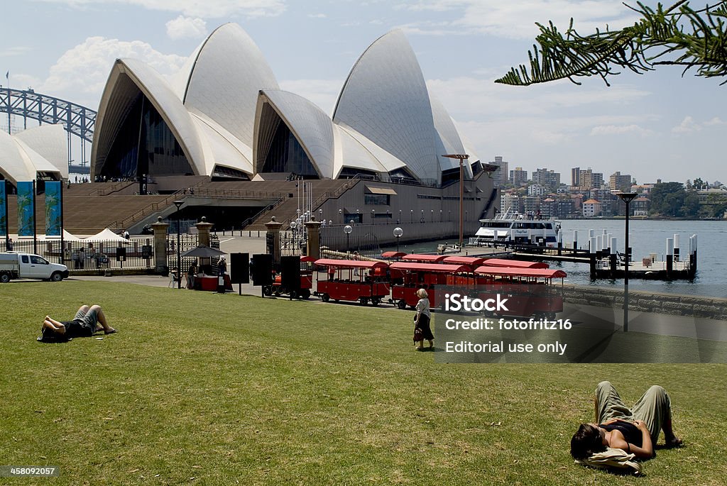 Australia, Sydney "Sydney, Australia - November 21st 2006: people relaxing in the green of the Royal Botanic Garden in front of the Sydney Opera House and Harbour Bridge in background" Architecture Stock Photo