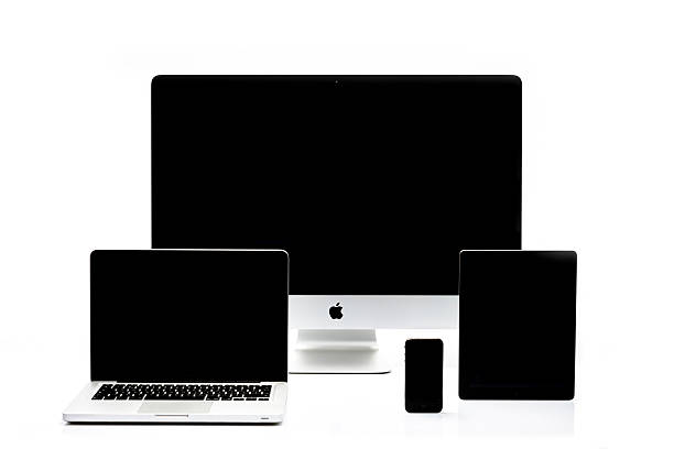 iMac, Macbook Pro, iPad and iPhone Kampen, The Netherlands - August 20, 2013: Studio shot of a Apple iMac desktop computer, Macbook Pro notebook, iPad tablet and iPhone mobile telephone isolated on a white background with a soft reflection in the foreground. apple device stock pictures, royalty-free photos & images