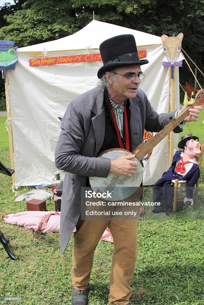 minstreling "Woodbury, USA - August 13, 2011: A man dressed in 188\'s attire of an mistrel man, The individual is one of many reenactors or living historians, who are impersonating, with the proper attire of the time, individuals of the civil war era. The individuals are taking part in the reenactment of the American Civil war saga \""On To Richmond\"" in the 1800\'s. The reenactment battle is one of the many battles of the war theatre, which is being portrayed as accurately as possible at what it was like at that time." Adult Stock Photo