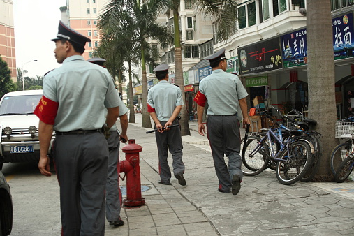 Shenzhen, P.R. China, 14. Oct. 2006: uniformed, communist (non-police) eye of the law with nightsticks and red armbands