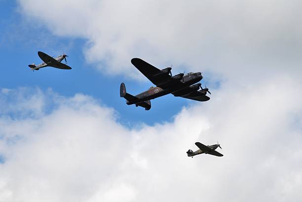 Battle of Britain Memorial Flight "Tenterden, England - May 14, 2011: The Battle of Britain Memorial Flight, comprising a Lancaster bomber flanked by Spitfire and Hurricane fighters, performs over Tenterden, Kent." spitfire stock pictures, royalty-free photos & images