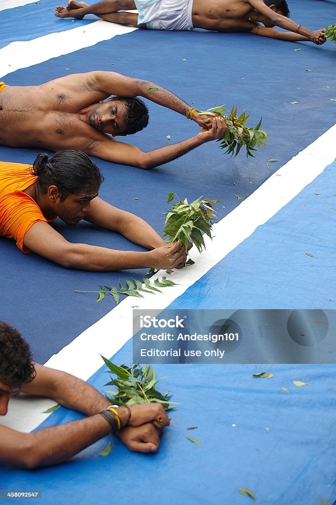 Hindu rituals "Singapore, Singapore - July 28 2005: Hindus doing ritual rolling (Angapirathatchanam) at Sri Mariamman Temple for the Thimithi Festival  in Chinatown Singapore" Adult Stock Photo