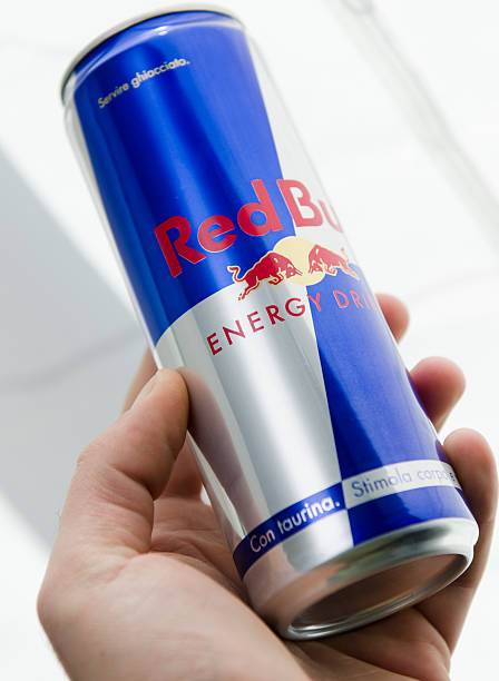 Hand Red Bull Cans Stock Photo - Download Image Now - Red Bull, Aluminum, Blue -