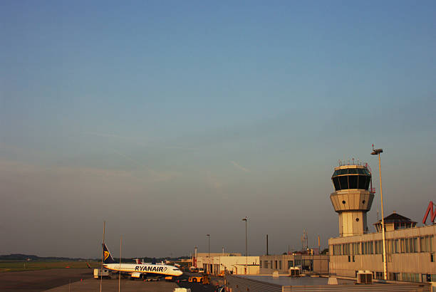 A large, empty and open runway at an airport, ready for takeoffs and landings.