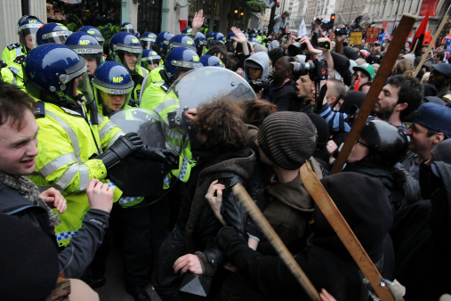 London, UK - March 26, 2011: Protesters and riot police clash during a large austerity rally in central London.