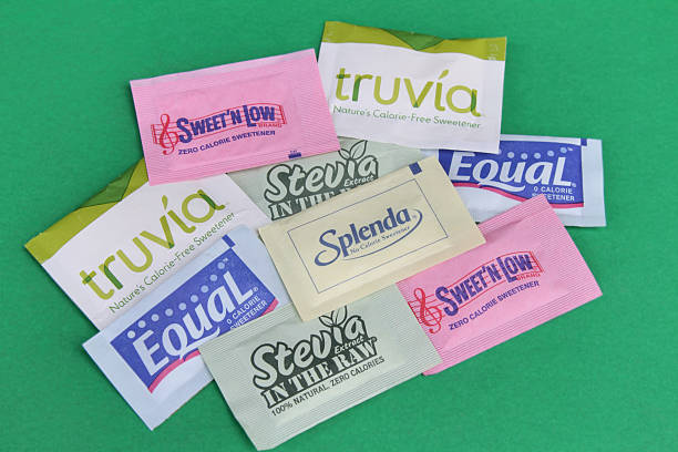 Sugar substitutes "West Palm Beach, USA - July 25, 2011: This image shows an assortment of zero calorie sweeteners used as sugar substitutes. Brands shown include SweetN Low, Truvia, Equal, Splenda, and Stevia in the Raw." aspartame stock pictures, royalty-free photos & images