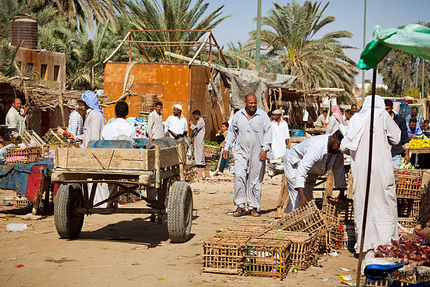 Siwa-Oase Egypt - November, 5th 2010: The inhabitants of the oasis of Siwa in purchasing your food at the street market. There are poultry, fruit and vegetables.