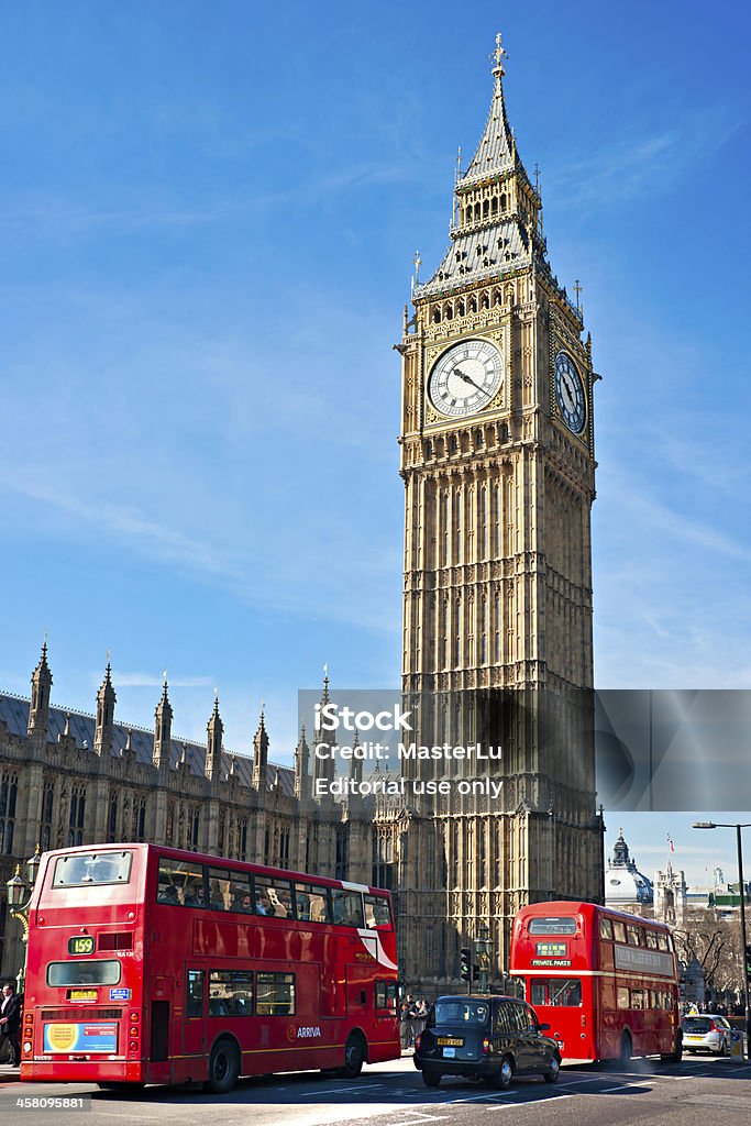 The Big Ben,  London, UK. London, United Kingdom - March, 19 2011: Wide angle view of the Big Ben with double-decker bus and a taxi. Big Ben is the largest four-faced chiming clock and was built in 1288. Architecture Stock Photo