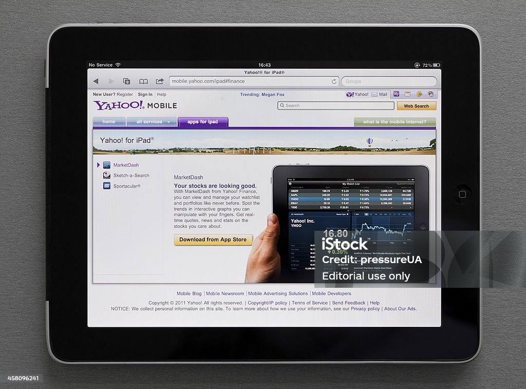Apple Ipad showing Yahoo web page "Kiev, Ukraine - May 17, 2011: Apple iPad, which lies on the table, shows Yahoo site with Marketdash download web page on screen. Apple iPad - a touch screen tablet pc which can be used for watching movies, listening music and reading books, playing games and browsing web pages in internet." Yahoo - Brand-Name Stock Photo