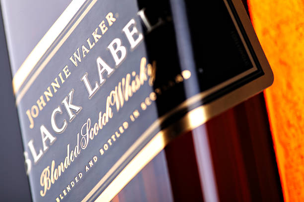 Johnnie Walker black label whiskey "Bucharest, Romania - April 17, 2012: Close-up shot of a bottle of Johnnie Walker whiskey. Johnnie Walker is a brand of Scotch Whisky owned by Diageo and originated in Kilmarnock, Ayrshire, Scotland." alcoholism alcohol addiction drunk stock pictures, royalty-free photos & images