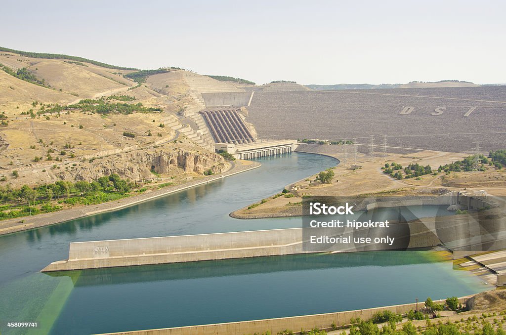 Ataturk Dam, Turkey "anlAurfa, Turkey - June 24, 2012: Ataturk Dam, Turkey, view from an elevated viewpoint at riverside. The Ataturk Dam, the sixth largest rock filled dam in the world, is the key structure for the development of the Lower Euphrates River region." Asia Stock Photo