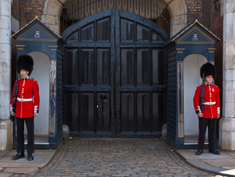 British guards in bearskin hats and red uniforms on parade in London, UK. Changing the guard takes place several times each week and is a very popular tourist destination