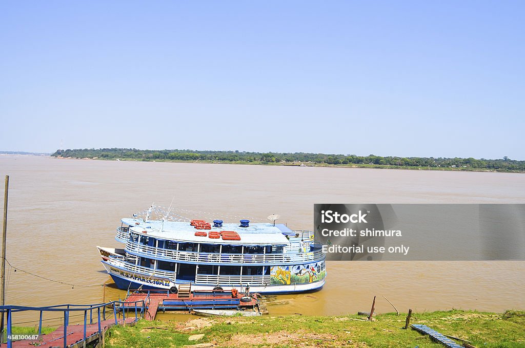 Boats in line at Madeira River - Amazonia region (closeup) "Porto Velho, Brazil - August 31, 2013: Boats in line at Madeira River - Amazonia region (closeup)Porto Velho is a Brazilian city and the capital of the state of RondA'nia. Situated on the right side of the Madeira River in northern Brazil. This city was founded by the American company Madeira Mamore Railway Company on July 4, 1907, during the construction of the Madeira-Mamore, commanded by U.S. magnate Percival Farquhar. On October 2, 1914 was legally established as a municipality of the Amazonas, becoming the state capital of RondA'nia in 1943 when it created the Federal Territory of Guapore.  With a population of 442 701 inhabitants, is the most populous city in the state,The Madeira River is a river in the Amazon River basin that bathes the states of RondA'nia and Amazonas. It is one of the main affluents of the Amazon River (Rio Amazonas). It has a total length of approximately 3315 km, being the 17th largest river in the world in extension." Rondonia State Stock Photo