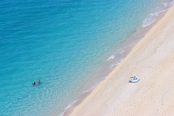 Couple swimming at the Egremni Beach - Lefkada Island (Greece) stock photo