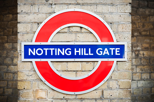 London, England - April 30, 2011: Notting Hill Gate Tube Stop Sign on wall inside rail station.