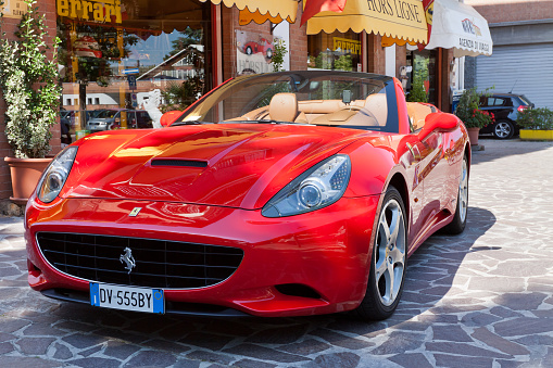 Maranello, Italy - May 30, 2011: A beautiful red Ferrari &amp;amp;quot;California&amp;amp;quot; parked in the street of Maranello, the town near Modena where is located the Ferrari factory.