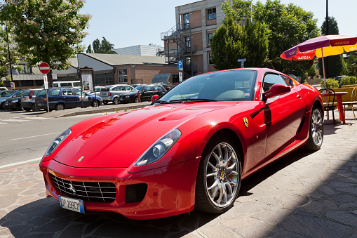 Maranello, Italy - May 30, 2011: A beautiful red Ferrari &amp;amp;quot;599 GTB Fiorano&amp;amp;quot; parked in the street of Maranello, the town near Modena where is located the Ferrari factory.