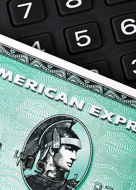 American Express card and number pad "Ratingen, Germany - June 21, 2011: Closeup of green American Express credit card on a number pad. AMEXCO is one of the biggest credit card companies worldwide. Studio shot." american express stock pictures, royalty-free photos & images