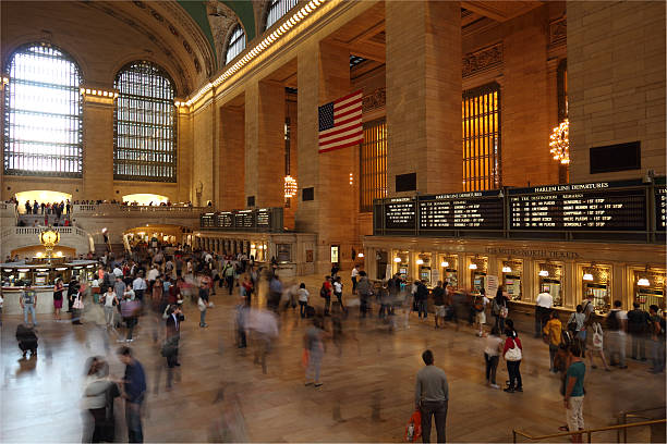 Grand Central Terminal "New York City, New York, USA - May 26, 2012: Grand Central Terminal with people walking about the station. This photo shows the ticket counters in the Main Concourse of the terminal. Originally opened in 1871, it is now one of the most popular tourist attractions in New York City today." ticker tape machine stock pictures, royalty-free photos & images