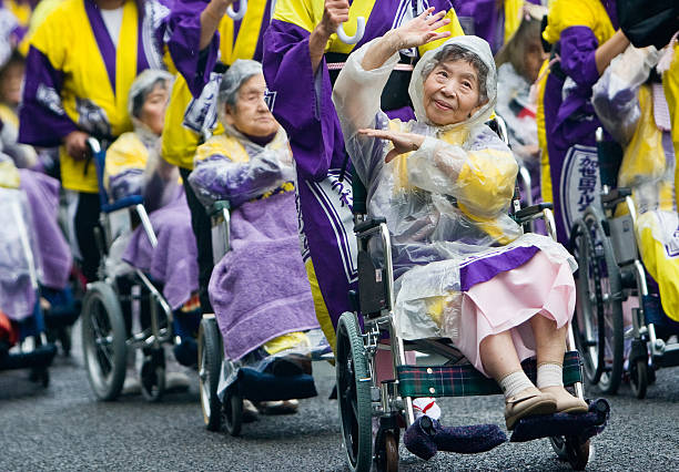 Elderly Japanese festival dancers in wheelchairs at Ohara Matsuri stock photo