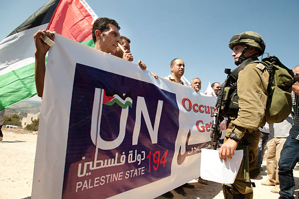 Demonstration for Palestine Statehood "Al-Walaja, Occupied Palestinian Territories - September 16, 2011: Protesters supporting Palestinian statehood confront Israeli soldiers in a demonstration in Al-Walaja." apartheid sign stock pictures, royalty-free photos & images