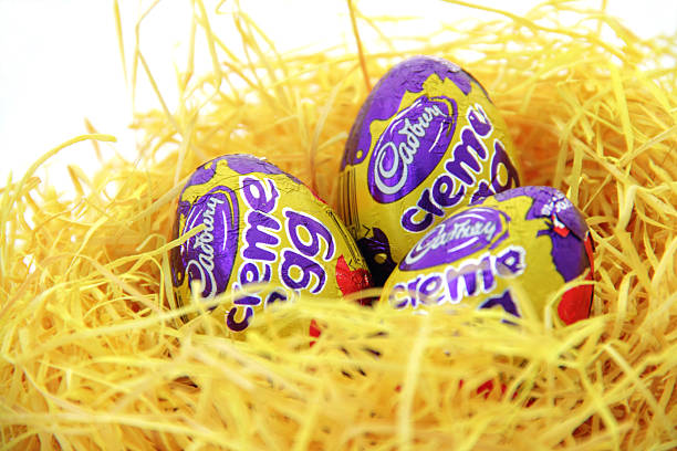 cadbury eggs "essen, germany -  April 13, 2011: cadbury easter eggs, resting in yellow nest" cadbury plc photos stock pictures, royalty-free photos & images