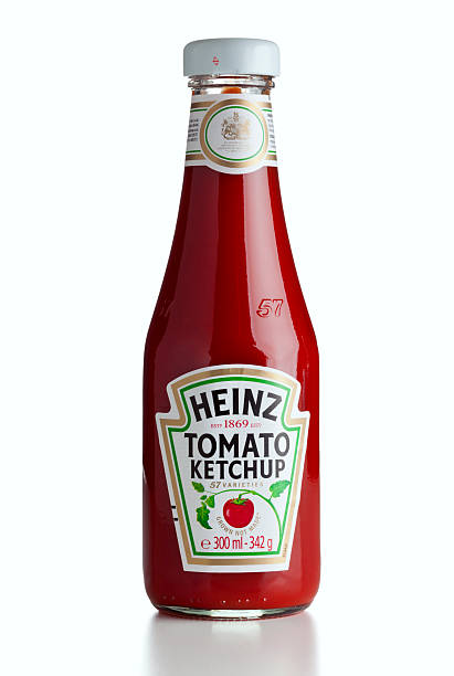 Heinz ketchup bottle isolated "Ratingen, Germany - July 13, 2011: A 300 ml bottle of Heinz Tomato Ketchup with labels for United Kingdom." ketchup stock pictures, royalty-free photos & images