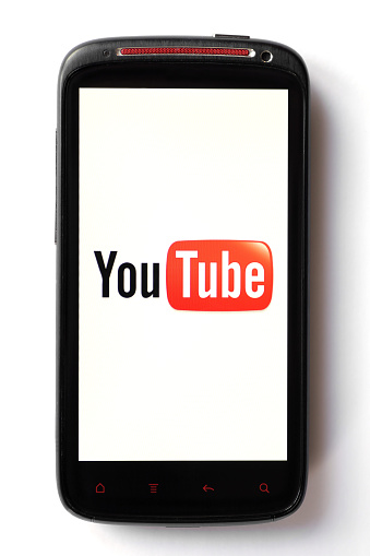 Bucharest, Romania - March 28, 2012: Youtube logo is displayed on a mobile phone screen. YouTube is a video-sharing website, on which users can upload, view and share videos.