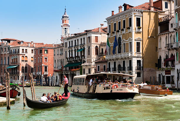 Tourists travelling on gondola and vaporetto at Grand Canal, Venice stock photo