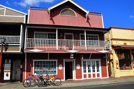 Lahaina, USA - July 16, 2012: Old town store fronts in Lahaina, Maui. Lahaina was once capital of Hawaii and home to the whaling industry. Now it is a pretty tourist town.