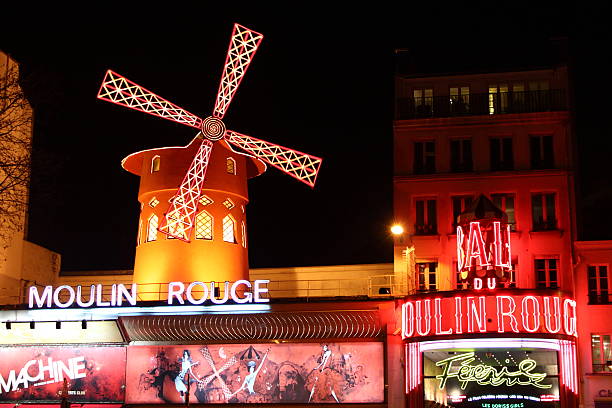 The Moulin Rouge "PARIS, FRANCE - March 13, 2011: The Moulin Rouge is a famous cabaret built in 1889, locating in the Paris red-light district of Pigalle." place pigalle stock pictures, royalty-free photos & images
