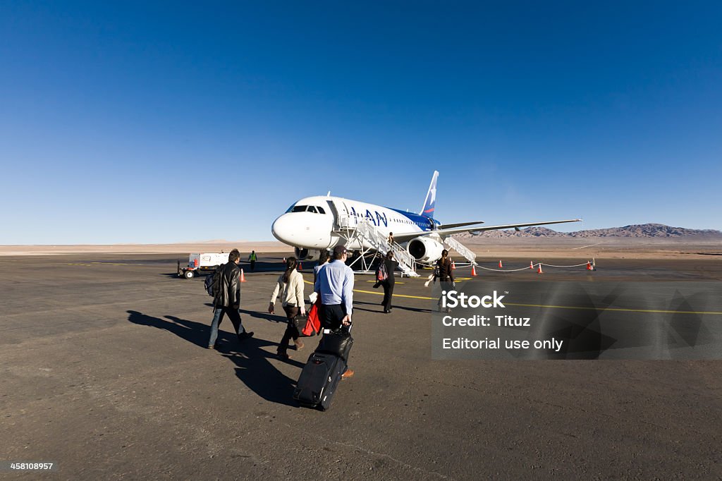 Calama Airport Calama, Chile - September 9th 2008: A group of passengers gets on the plane at the airport Adult Stock Photo