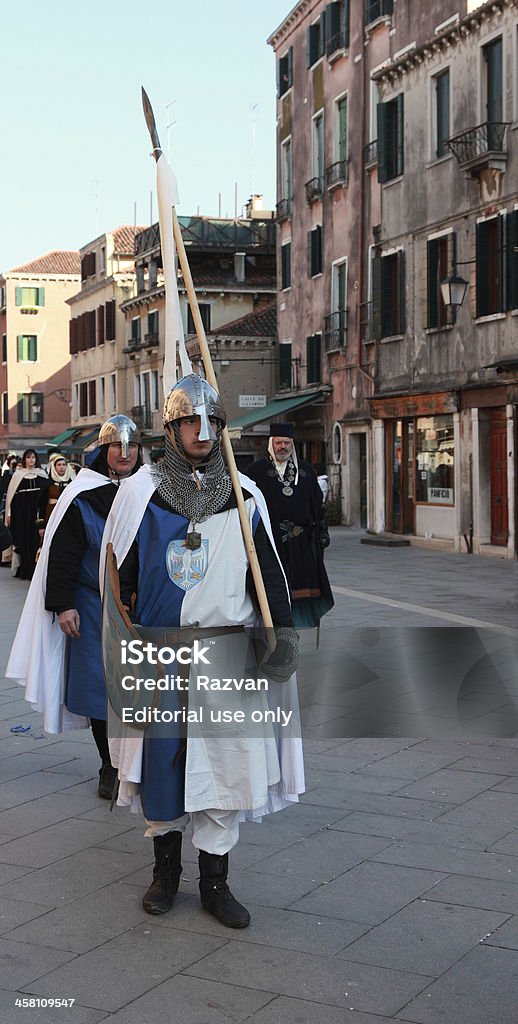 Standard bearer "Venice,Italy,February 26th 2011: Young man disguised as a medieval standard bearer marching in a costumes parade on Sestiere Castello in Venice,during The Carnival days.The Carnival of Venice (Carnevale di Venezia) is an annual festival, held in Venice, Italy and is now established as one of the world\'s most colourful must-see events." Adult Stock Photo