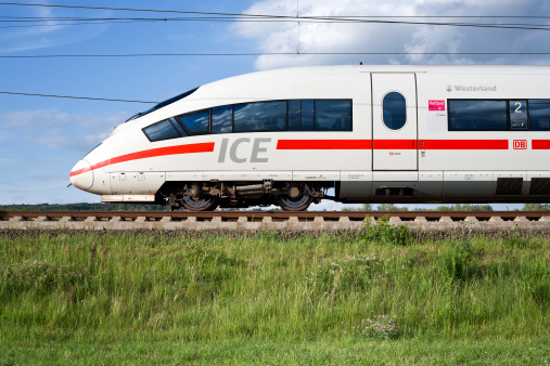 Kansas City, United States – October 22, 2022: An Amtrak train driving against the scenic fall forest in Kansas City, US